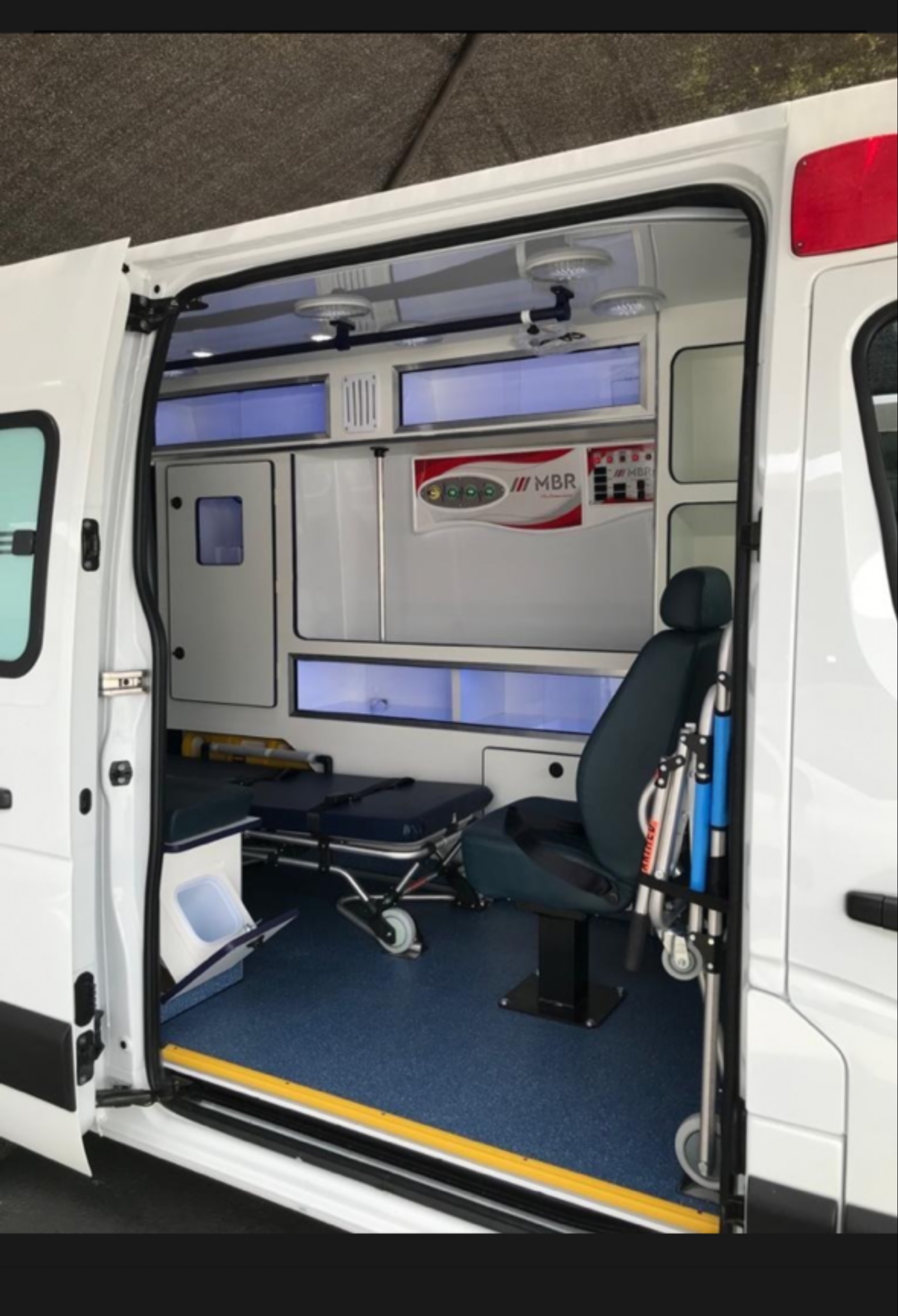 Interior de ambulancia com cadeira e maca recolhida